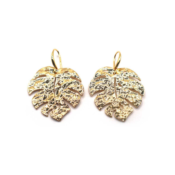 Gold leaf-shaped earrings on a white background