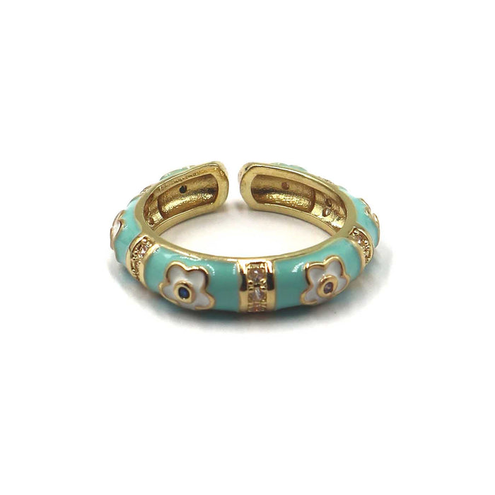 A gold-plated open cuff bangle bracelet with light turquoise enamel and white enamel floral motifs, shown on a plain white background.