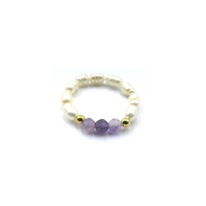 A beaded stretch bracelet featuring cream-colored baroque pearls, three faceted purple amethyst beads, and two small gold spacer beads, displayed on a clean white background with product codes.